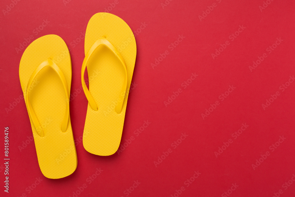 Bright yellow flip-flops on color background, top view. Summer concept Bright yellow flip-flops on color background, top view. Summer concept