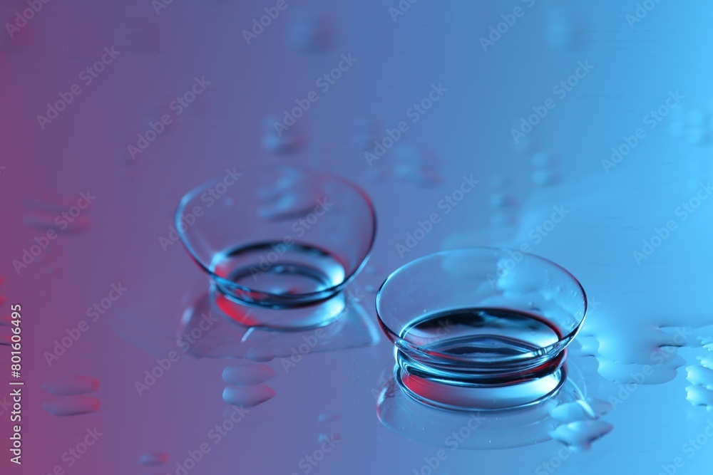 Pair of contact lenses on wet mirror surface Pair of contact lenses on wet mirror surface