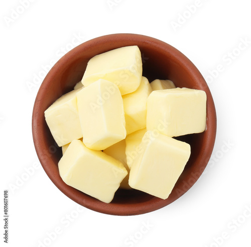 Tasty butter cubes in bowl isolated on white, top view