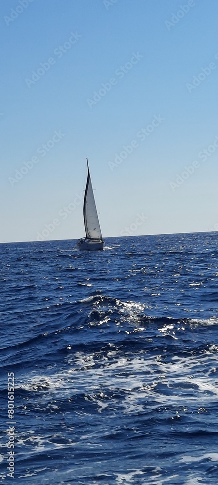Obraz premium Yacht sailing on opened sea. Sailing boat. Yachting photo. Sailing photo. Yachting at windy day. Yacht. Sailboat. Sailing. Ship yachts with sails in the open Sea. Sailboat in the sea in the sunlight