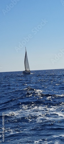 Yacht sailing on opened sea. Sailing boat. Yachting photo. Sailing photo. Yachting at windy day. Yacht. Sailboat. Sailing. Ship yachts with sails in the open Sea. Sailboat in the sea in the sunlight 