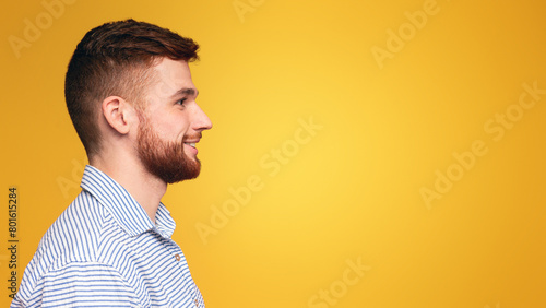 A man with a beard wearing a striped shirt.