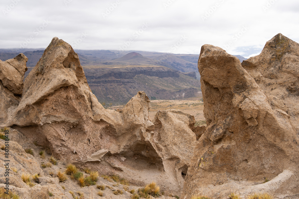 Fototapeta premium Mountain landscape with giant rocks in the foreground at Los Bolillos de Varvarco, Neuquen, Patagonia.