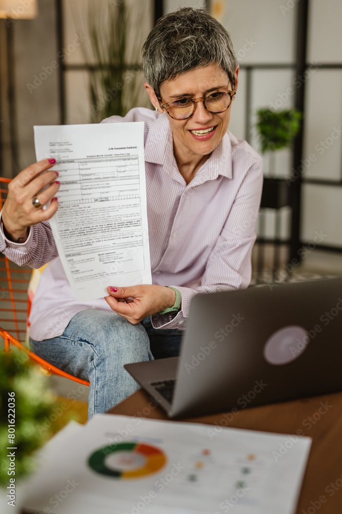 Naklejka premium Mature woman share document and have consultation via video call
