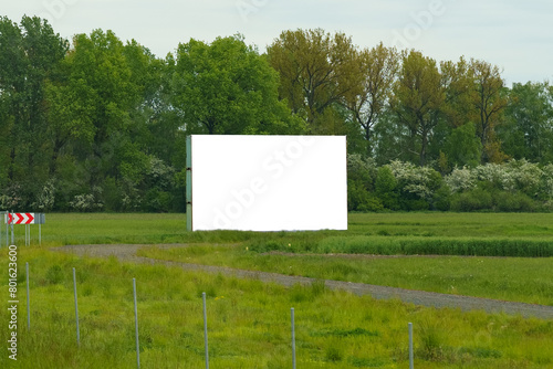 Empty Billboard in Field With Trees