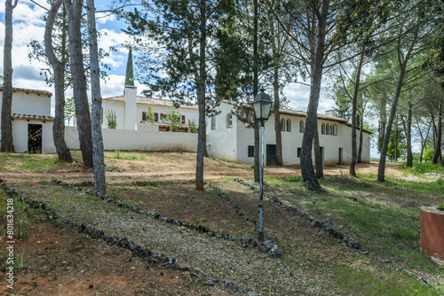 The Andalusian-style farmhouse with a small pine forest and paths marked with stones and lampposts photo