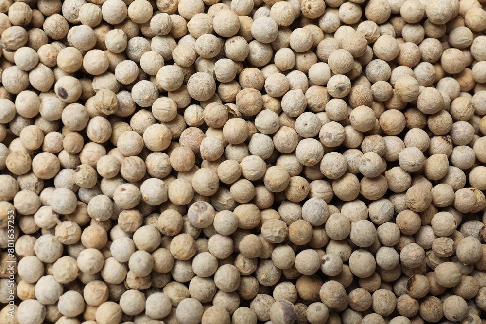 Aromatic spice. White peppers as background, top view Aromatic spice. White peppers as background, top view