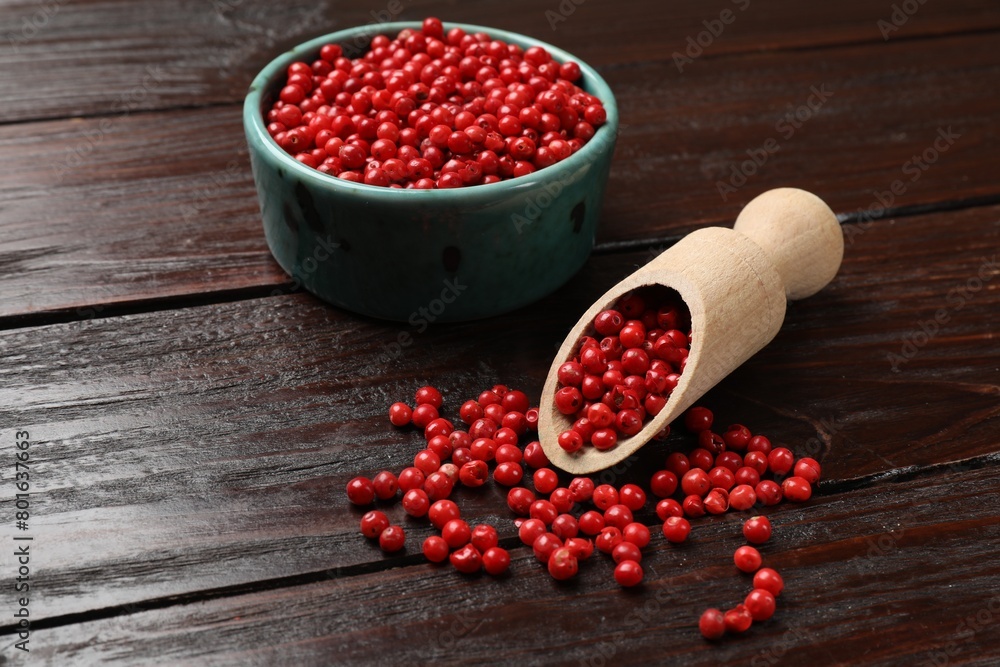Aromatic spice. Red pepper in bowl and scoop on wooden table, closeup Aromatic spice. Red pepper in bowl and scoop on wooden table, closeup