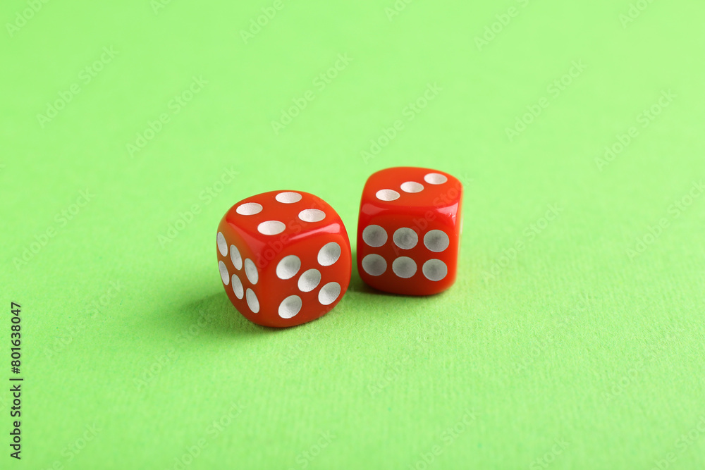 Two red game dices on green background, closeup Two red game dices on green background, closeup