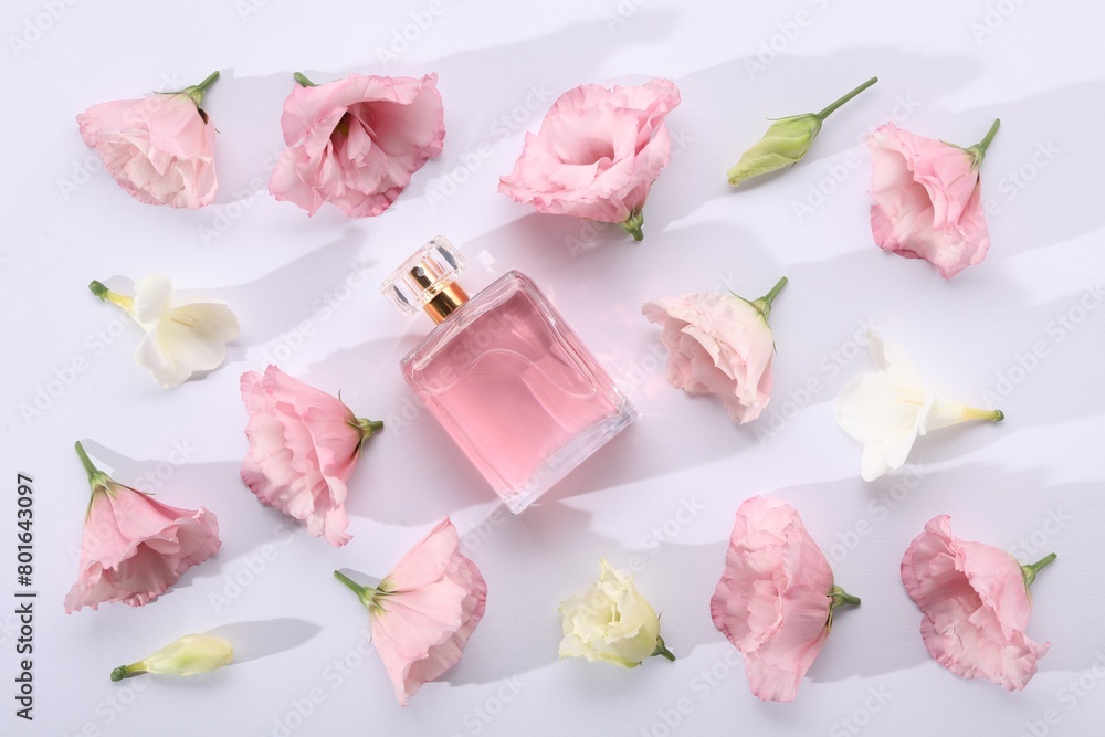 Luxury perfume and floral decor on white background, flat lay Luxury perfume and floral decor on white background, flat lay