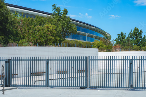 Принти на полотні Modern architectural structure with curved design, glass panels, greenery and metal fence likely part of Apple office complex in Mountain View, California