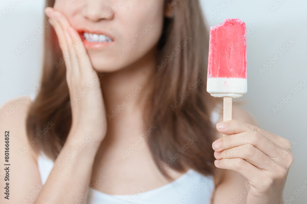 Teeth Sensitive to Cold concept. woman hold Ice cream and having