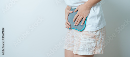 Menstruation period cycle of monthly and Stomachache concepts. woman having abdomen pain and menstrual ache with hot water bottle, illness female suffer from premenstrual ache and body Health problem photo
