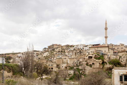 Cappadocia, Turkey -24 April 2024, View of the town of Ortahisar with the minaret of the mosque in the foreground and the valley of Cappadocia in the background near the town of Goreme, (ID: 801667627)