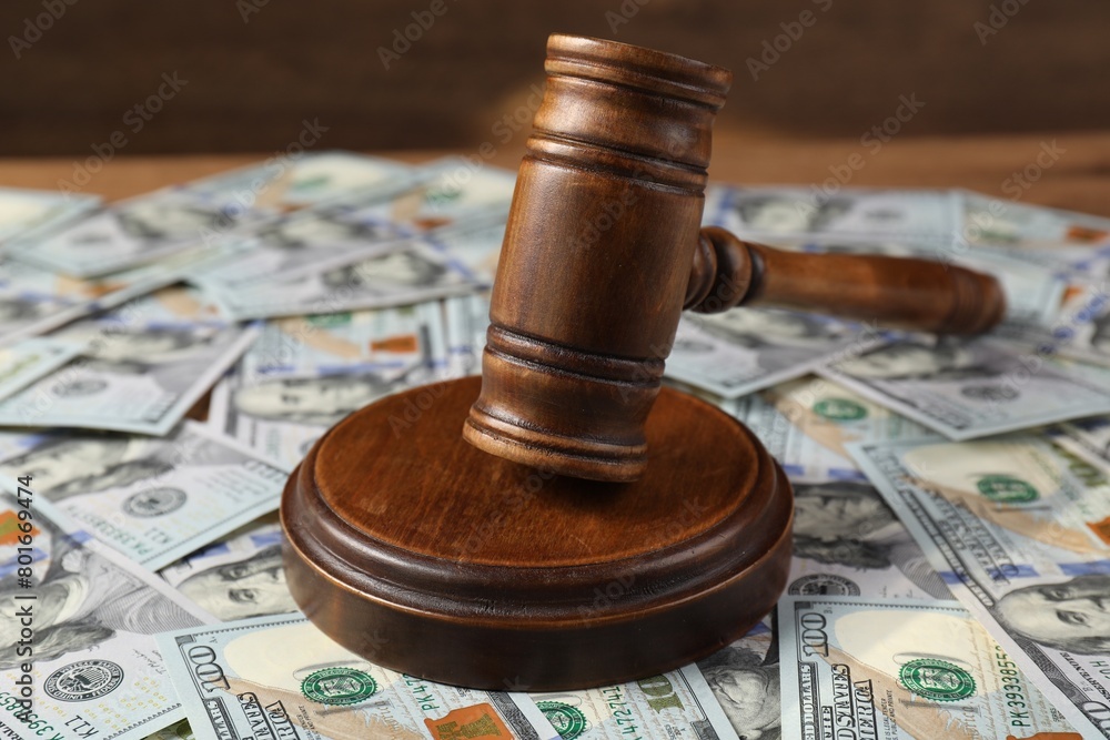 Judge's gavel and money on wooden table, closeup Judge's gavel and money on wooden table, closeup
