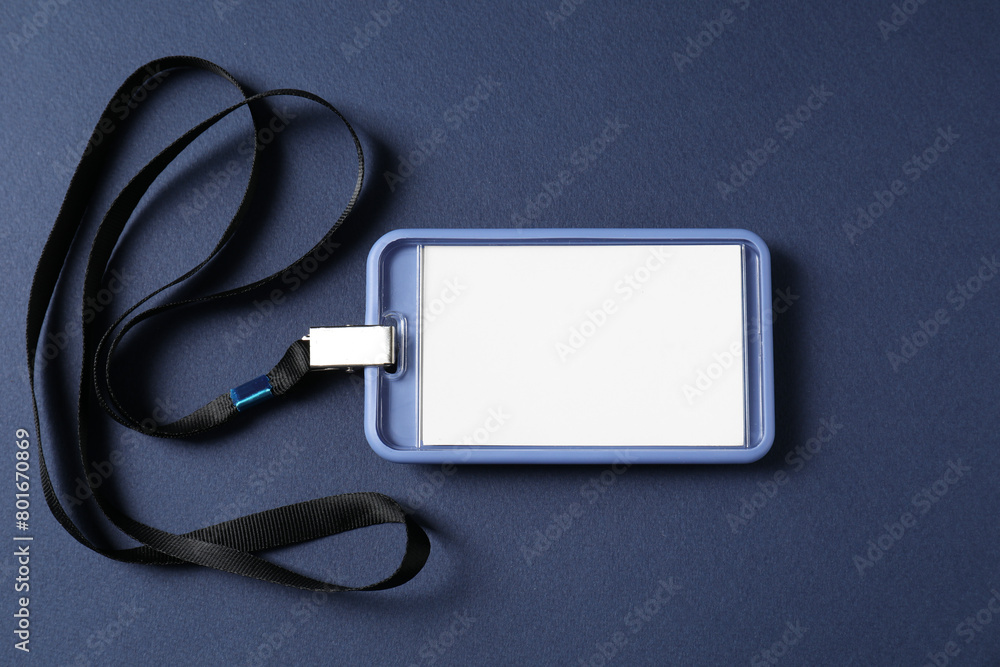 Blank badge with string on blue background, top view Blank badge with string on blue background, top view