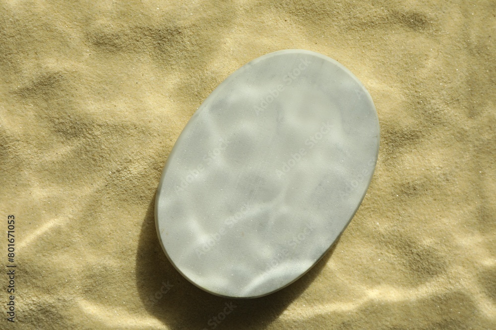 Obraz premium Stylish presentation for product. Stone podium on sand, top view