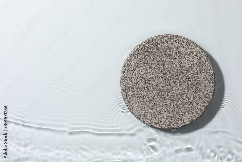 Presentation of product. Stone podium in water on white background, top view. Space for text Presentation of product. Stone podium in water on white background, top view. Space for text