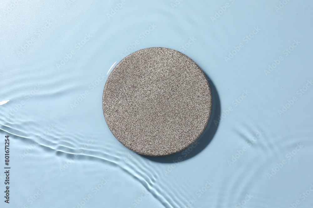 Obraz premium Presentation for product. Stone podium in water on light blue background, top view