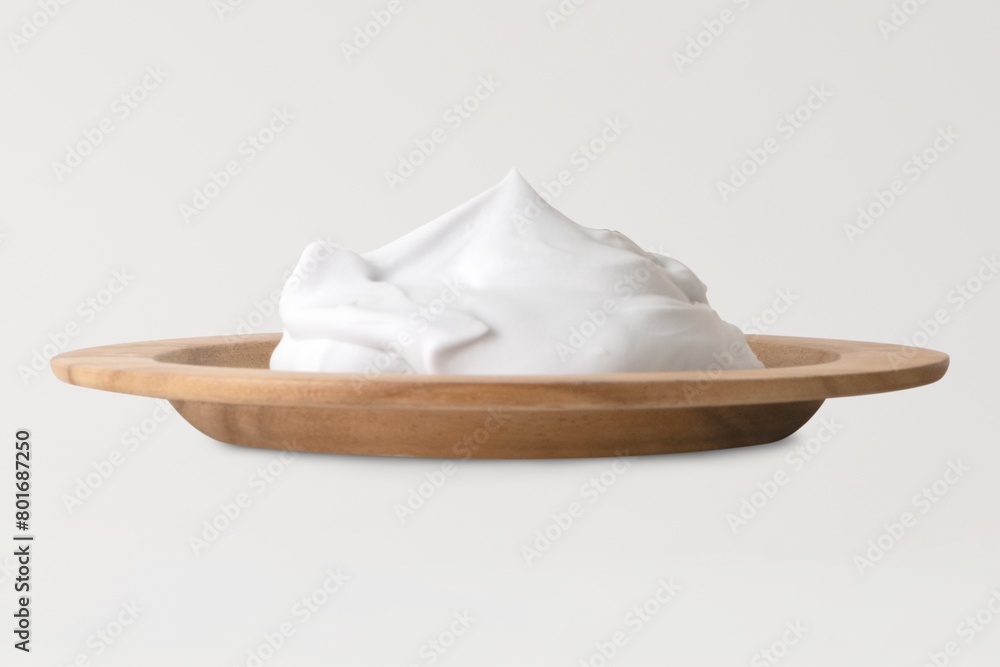 Shaving cream on wooden plate, men's grooming foam Shaving cream on wooden plate, men's grooming foam