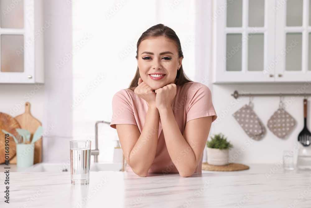 Happy woman at white marble table in kitchen Happy woman at white marble table in kitchen