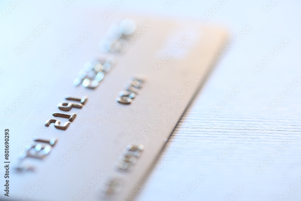 One credit card on light background, macro view. Space for text One credit card on light background, macro view. Space for text