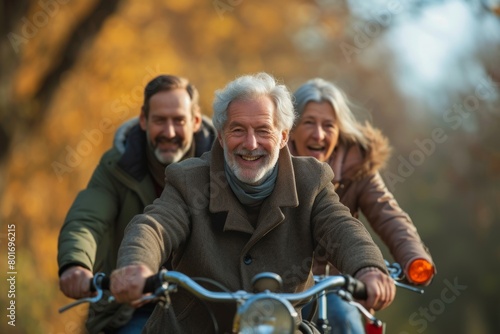 Happy senior couple riding a motorcycle in autumn park. They are smiling and looking at camera. © Iigo