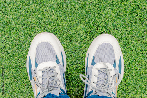 overhead view of feet with sports sneakers