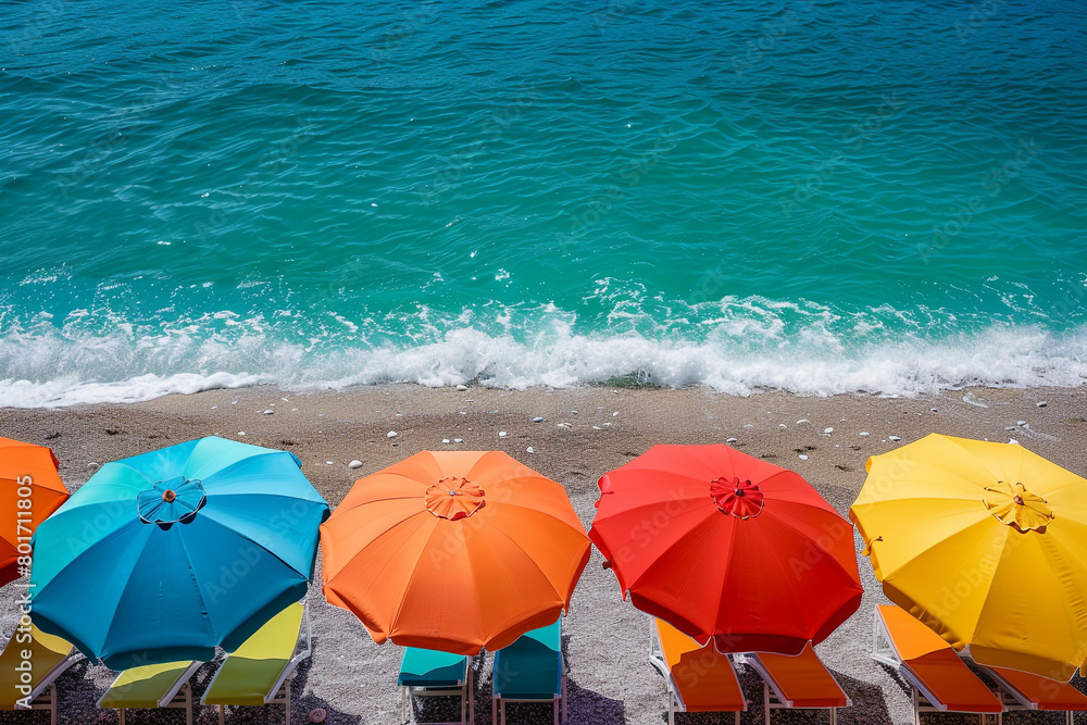 A cluster of vibrant beach umbrellas lining the shore, providing shelter from the midday sun.