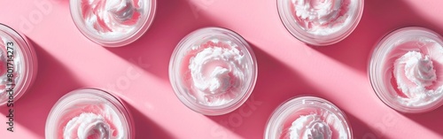 Minimalist Skincare: Closed Jars of Cream in a Regular Pattern on Pastel Pink Background