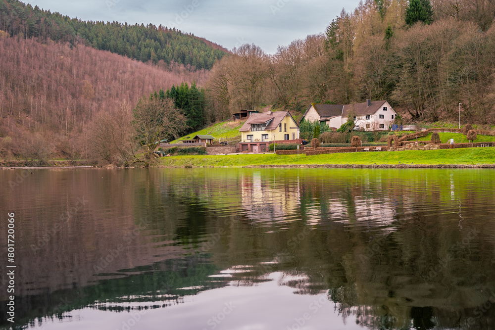 a house is on the water with a house in the background Germany EinRuhr