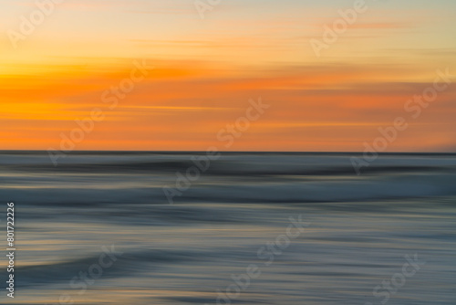 Golden sunset over the Pacific ocean. Abstract seascape  motion blur  vibrant colors  copy space