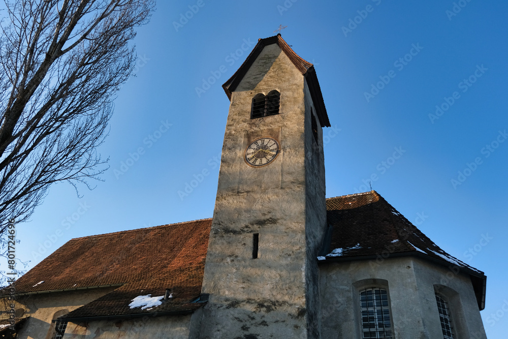 A large clock tower with a red roof and a white clock face