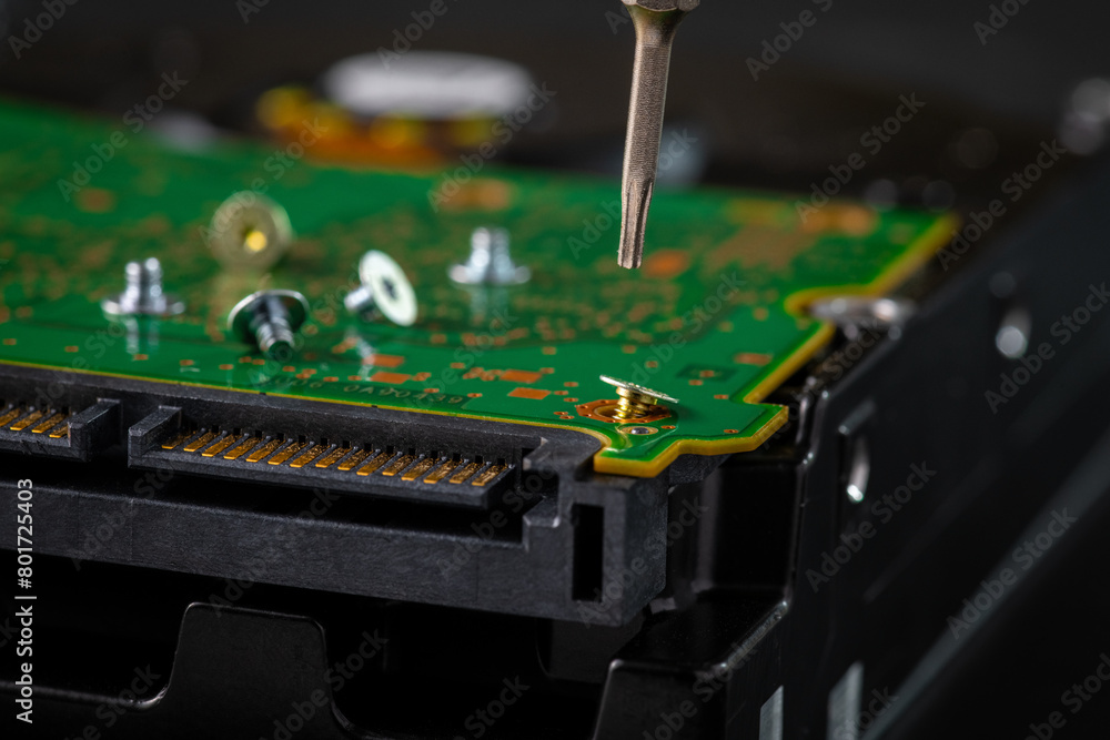 Hard disk drive and printed circuit board with SATA power connector. Magnetic driver torx bit and small machine screw Hard disk drive and printed circuit board with SATA power connector. Magnetic driver torx bit and small machine screw