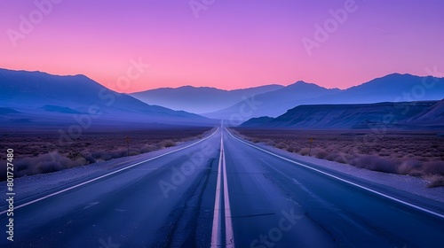 A car trip adventure into the wild desert highway of Arizona and California, with a road stretching into the distance, mountains silhouetted against a purple sunset sky.