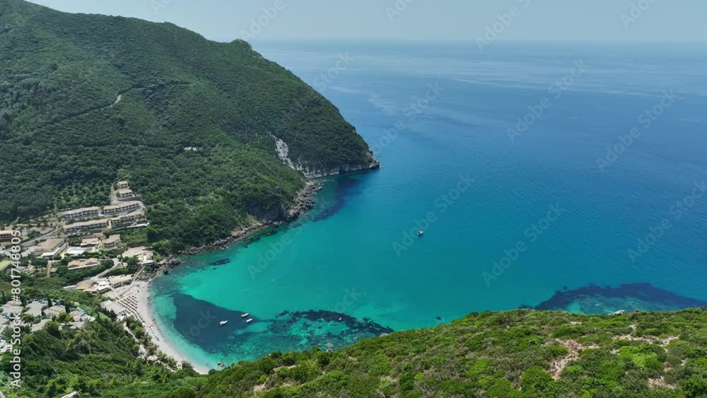 Coastline of Corfu Island with turquoise waters, boats, and green hills, aerial view Coastline of Corfu Island with turquoise waters, boats, and green hills, aerial view