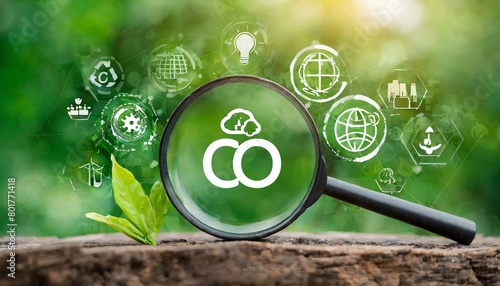 Magnifying glass with reduce CO2 emissions carbon symbol, on green background for climate change to limit global warming