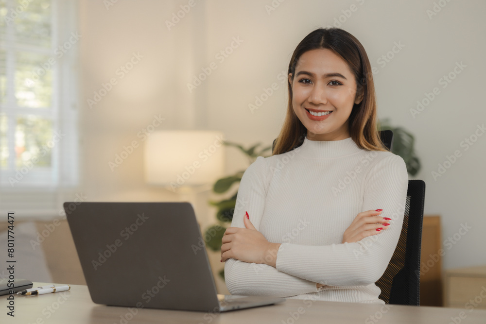 A beautiful Asian woman is sitting and working in her home office, A female employee is working by wirelessly connecting to a colleague at her own home. A beautiful Asian woman is sitting and working in her home office, A female employee is working by wirelessly connecting to a colleague at her own home.