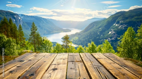 The inviting warmth of a wooden tabletop set against the sunlit panorama of a Norwegian fjord and lush green hills.