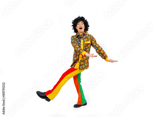 Asian hippie man dress in 80s vintage fashion with colorful retro  funk disco clothing while dancing isolated on white background for fancy outfit party and pop culture concept