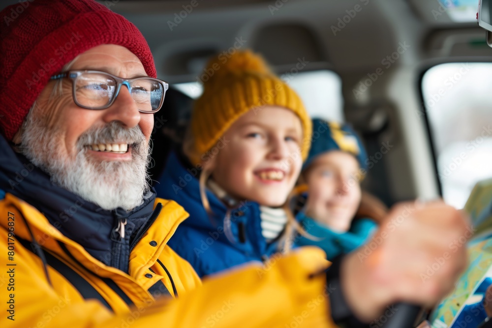 Cheerful senior man with a beard and two happy grandchildren using a map during a family car trip