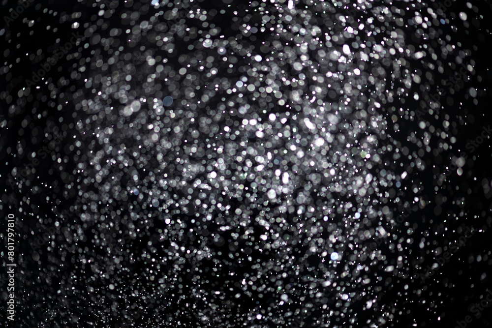 Obraz premium White falling glitter sequin confetti on black background
