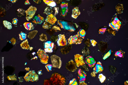 Brilliant, glowing grains of sand from California under the microscope.