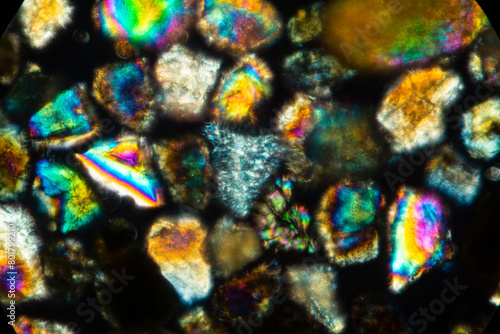 Brilliant, glowing grains of sand from California under the microscope.