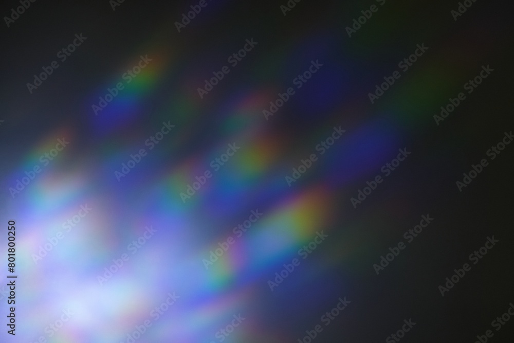 Iridescent rainbow blue prism light flare on black background