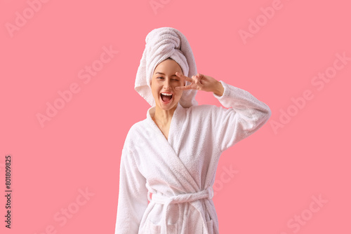 Young woman in bathrobe aft...