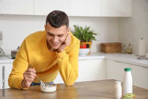 Young man with tasty yogurt...