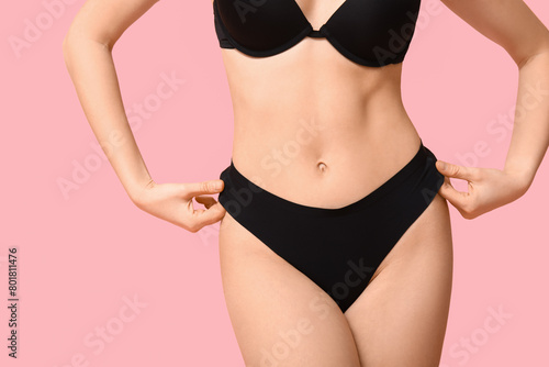 Attractive young woman in black underwear on pink background, closeup © Pixel-Shot