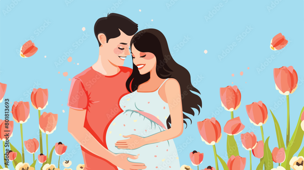 Young pregnant couple with tulips on blue background