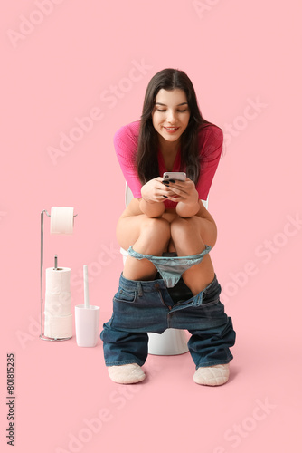 Young woman using mobile ph...